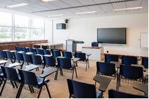 Empty classrooms with chairs, desks, and a digital board