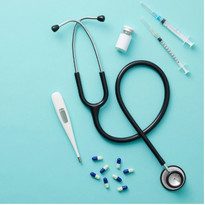 Medical equipment including stethoscope, thermometer, syringe, and pills.